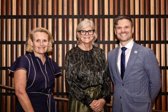 Caroline Butler-Bowdon, Her Excellency The Governor-General, Dr Simon Polson against a wooden panel backdrop.